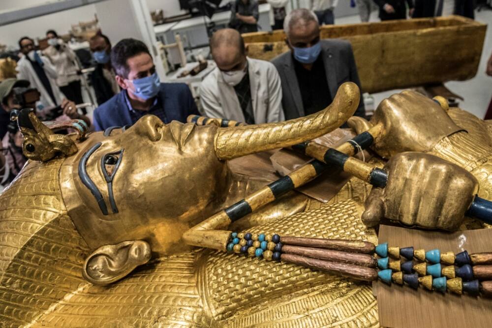 The golden sarcophagus of the Egyptian pharaoh Tutankhamun in a restoration lab at the newly-built Grand Egyptian Museum in Giza