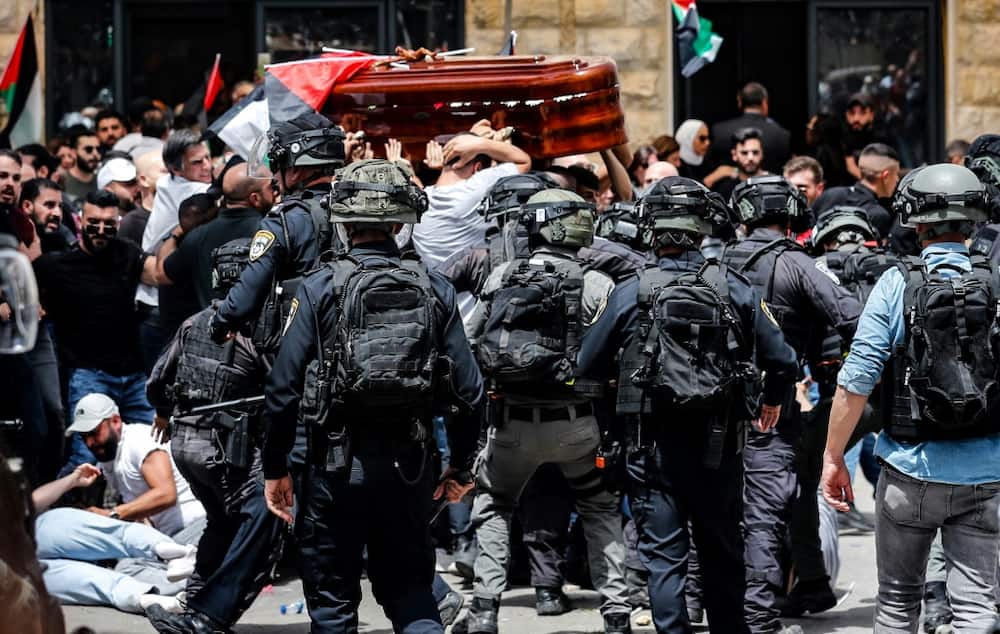 Violence erupts between Israeli security forces and Palestinian mourners carrying the casket of slain Al-Jazeera journalist Shireen Abu Akleh on May 13, 2022 in Jerusalem