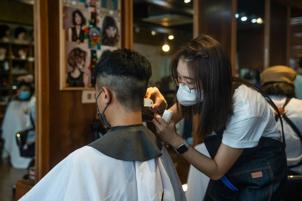A student (R) learns hairdressing skills -- instructor Jason Yip said the hairdressing industry has a relatively low entry threshold and Hong Kongers can get a job quickly