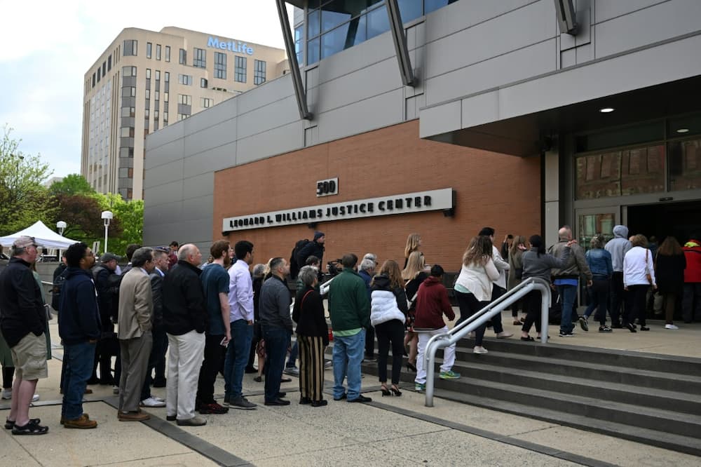 Members of the public queue to enter a Delaware court to watch a major defamation trial between Dominion Voting Systems and Fox News on April 18, 2023