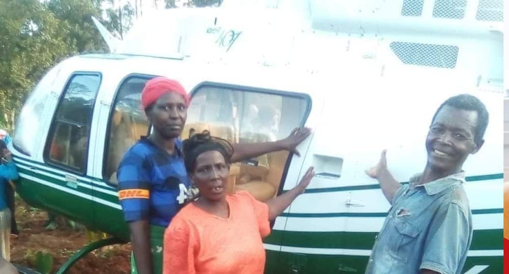 Excited villagers take photo with 5Y-PKI helicopter.
