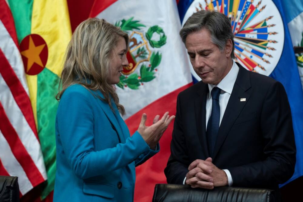 US Secretary of State Antony Blinken speaks with Canadian Foreign Minister Melanie Joly  during a meeting about aid policy to Haiti during a meeting of the Organization of American States in Lima on October 6, 2022