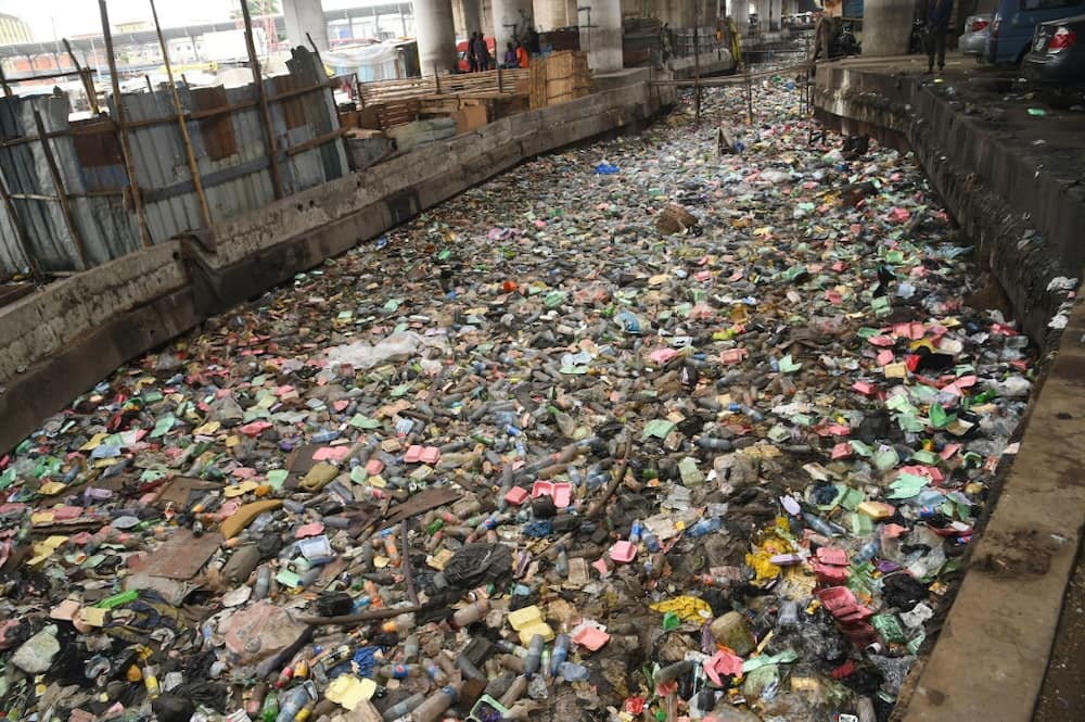 A Lagos drain clogged by waste. Every year, Nigeria spews 200,000 tonnes of plastic into the Atlantic, the UN says