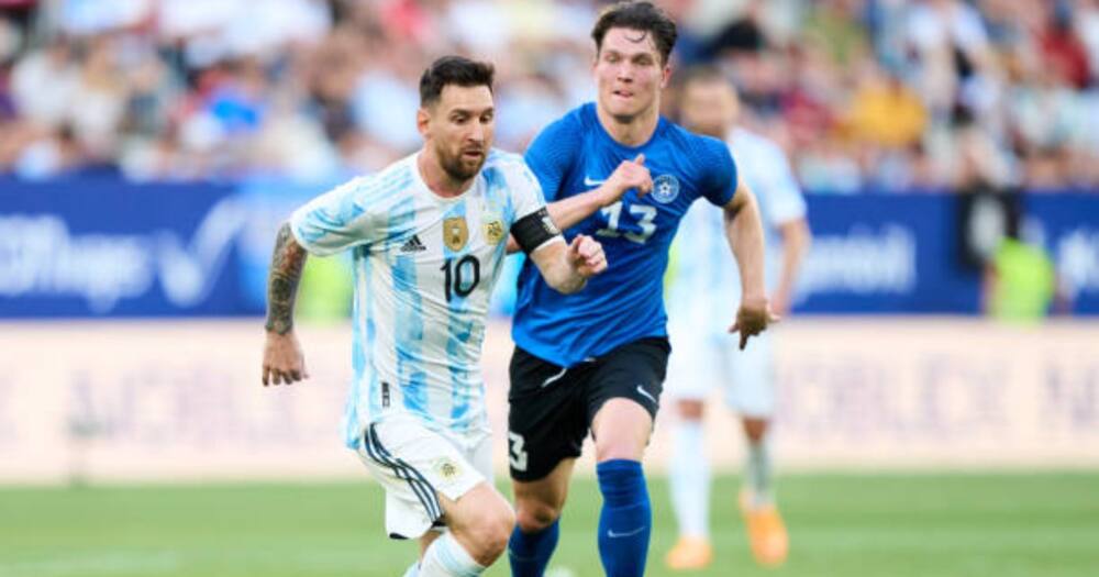 Lionel Messi of Argentina duels for the ball with Soomets Markus of Estonia during the international friendly match between Argentina and Estonia at Estadio El Sadar on June 05, 2022 in Pamplona, Spain. (Photo by Juan Manuel Serrano Arce/Getty Images)