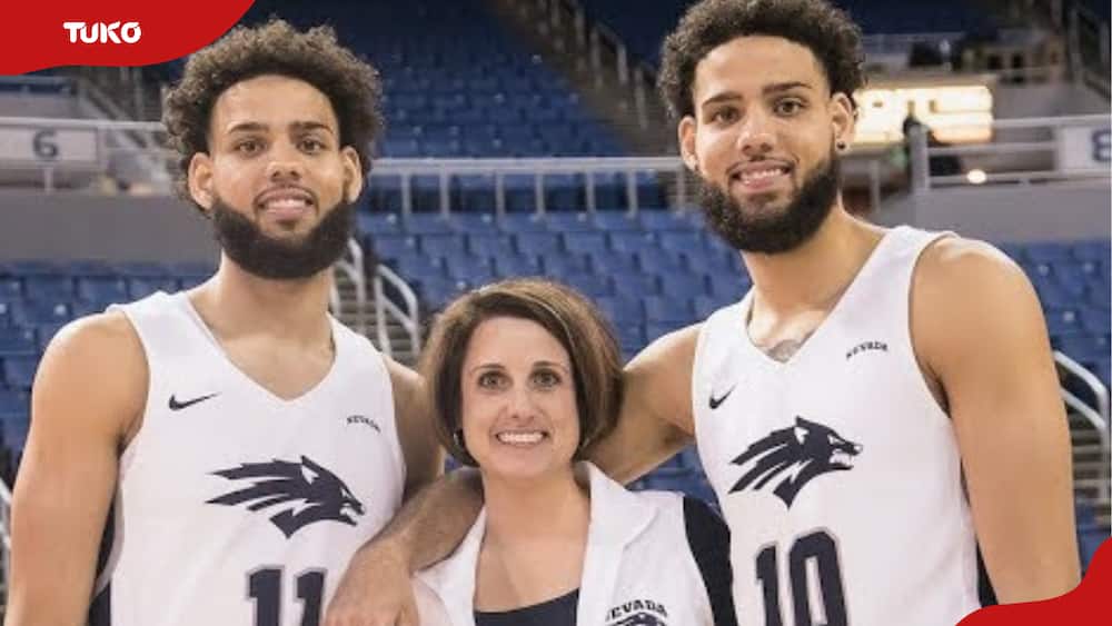 Caleb Martin, Jenny Bennett and Cody Martin pose for a photo after a basketball game