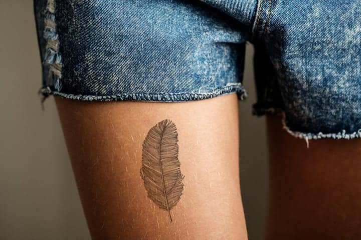 Feminine classy thigh tattoos