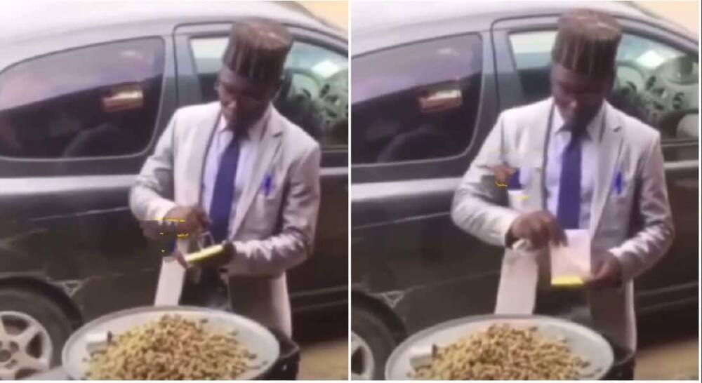 Nigerian groundnut seller seen issuing receipt to customer.