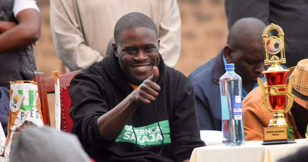 Governor Johnson Sakaja gestures at a supporter.