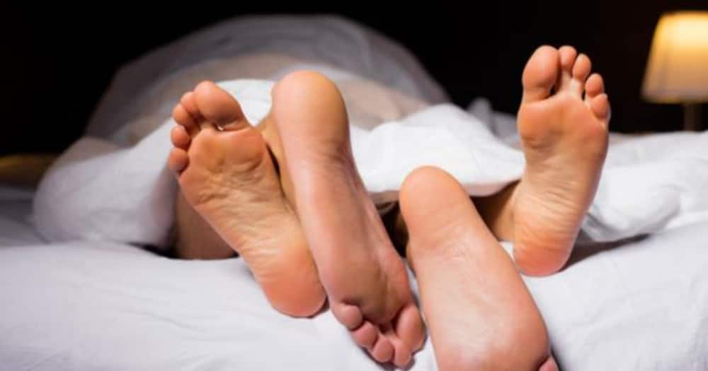 A man and a woman in bed. Photo: Getty Images.