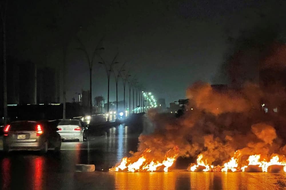 Tyres burnt at a road blockade during overnight protests in the Libyan capital Tripoli