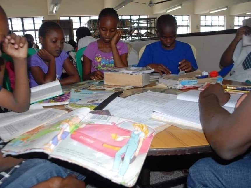 Image result for students sharing textbooks in schools in Kenya