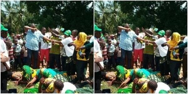 Women lie down as MP walks on their backs(photo)