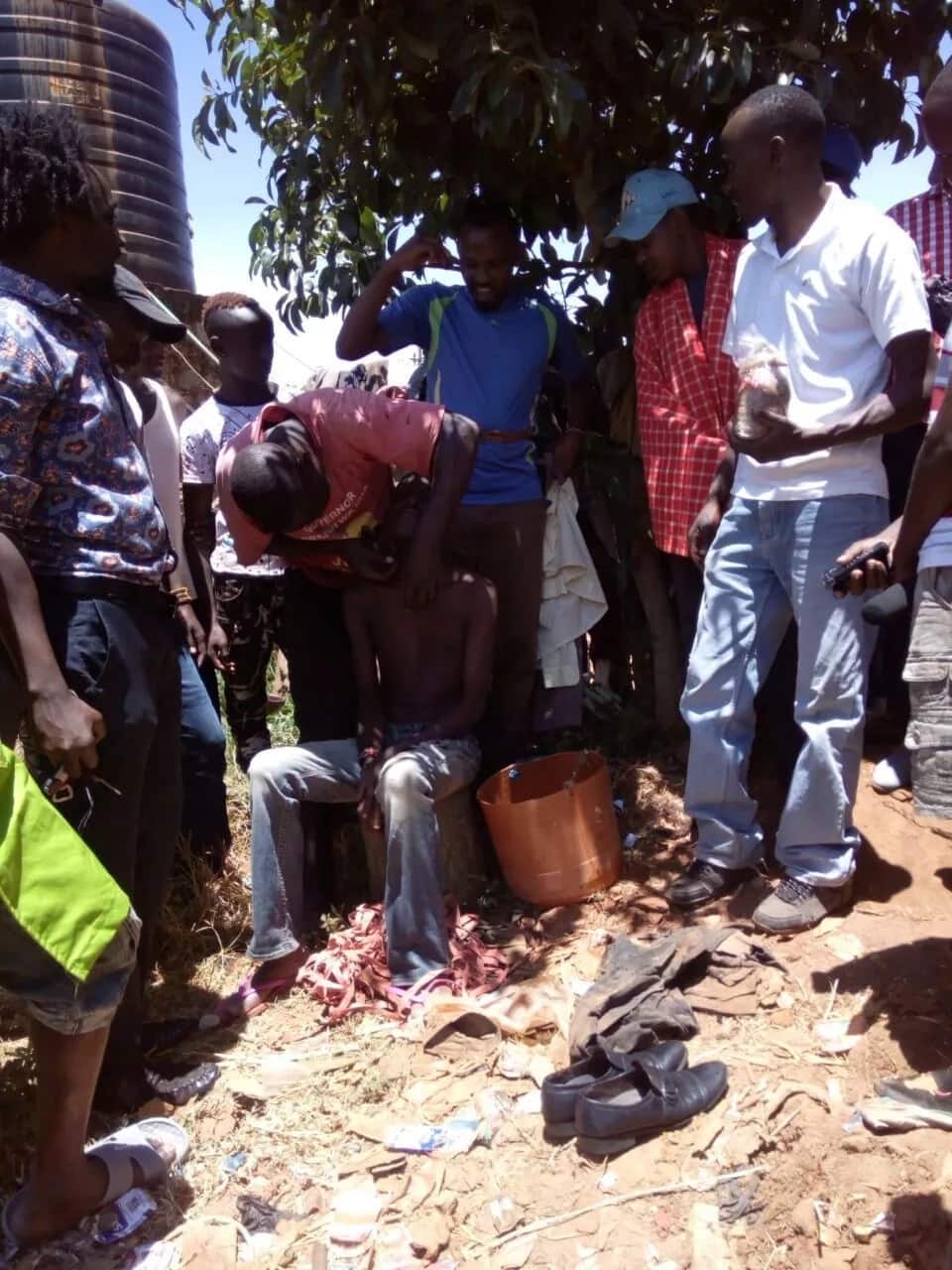 Stinking Murang'a taxi driver forcibly washed in public by colleagues. Photo: Mark Wachira/TUKO