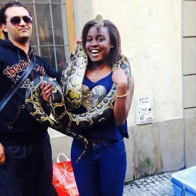 A creepy photo of Mudavadi's daughter playing with a big dangerous snake