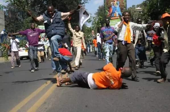 Women lie down as MP walks on their backs(photo)