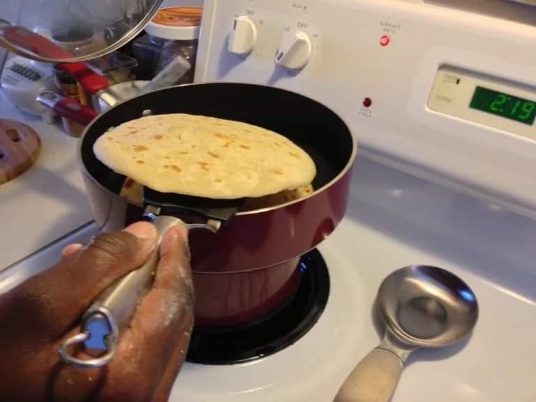 A person cooking chapati.