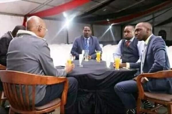 Governor Munya 'finishes' his juice before Larry Madowo and other guests start