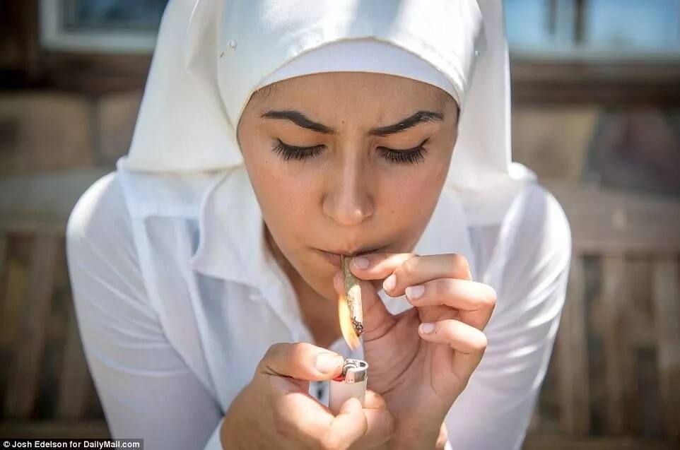 A sister pictured lighting up a joint. Photo: Daily Mail/Josh Edelson
