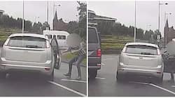 Road madness! Man desperately tries to stop woman who hit his car from driving off but fails
