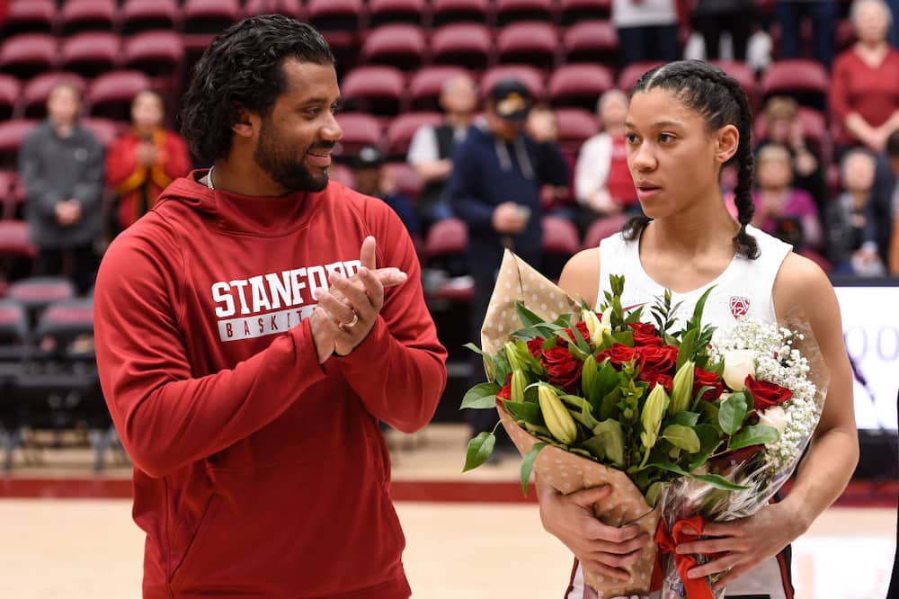 Russell Wilson congratulates his younger sister Anna Wilson #3 of the Stanford Cardinal on senior day after the NCAA women's basketball game against the USC Trojans.