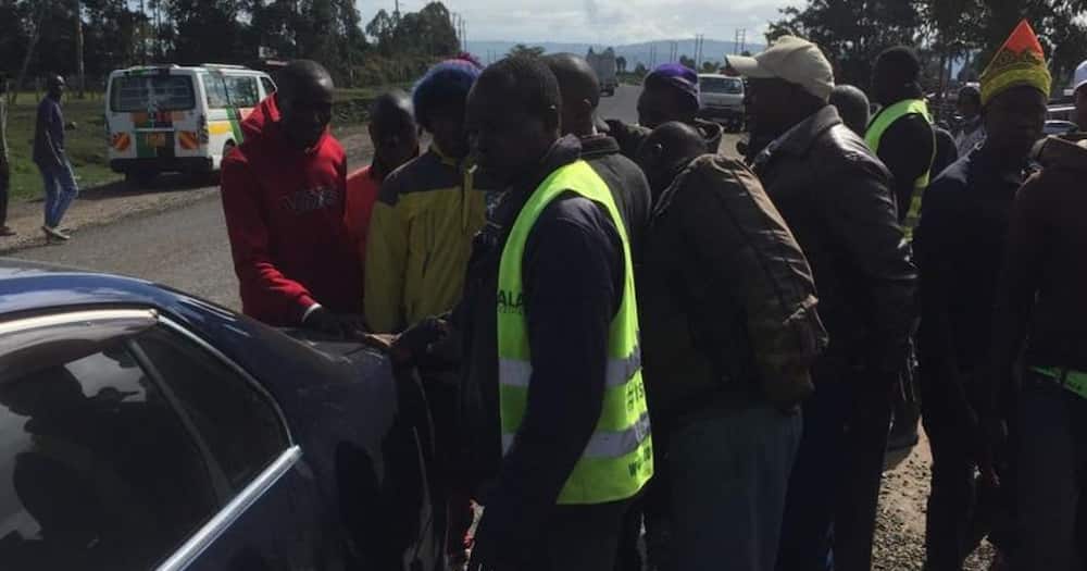 A woman touched after boda boda riders ganged against one of their own who hit her car from behind.