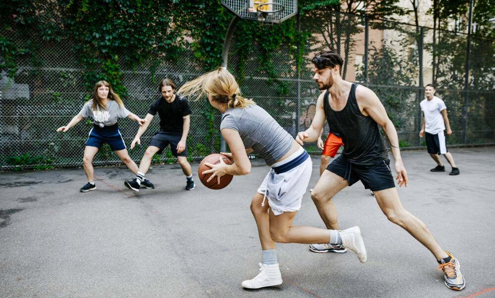 A group of people are playing basketball
