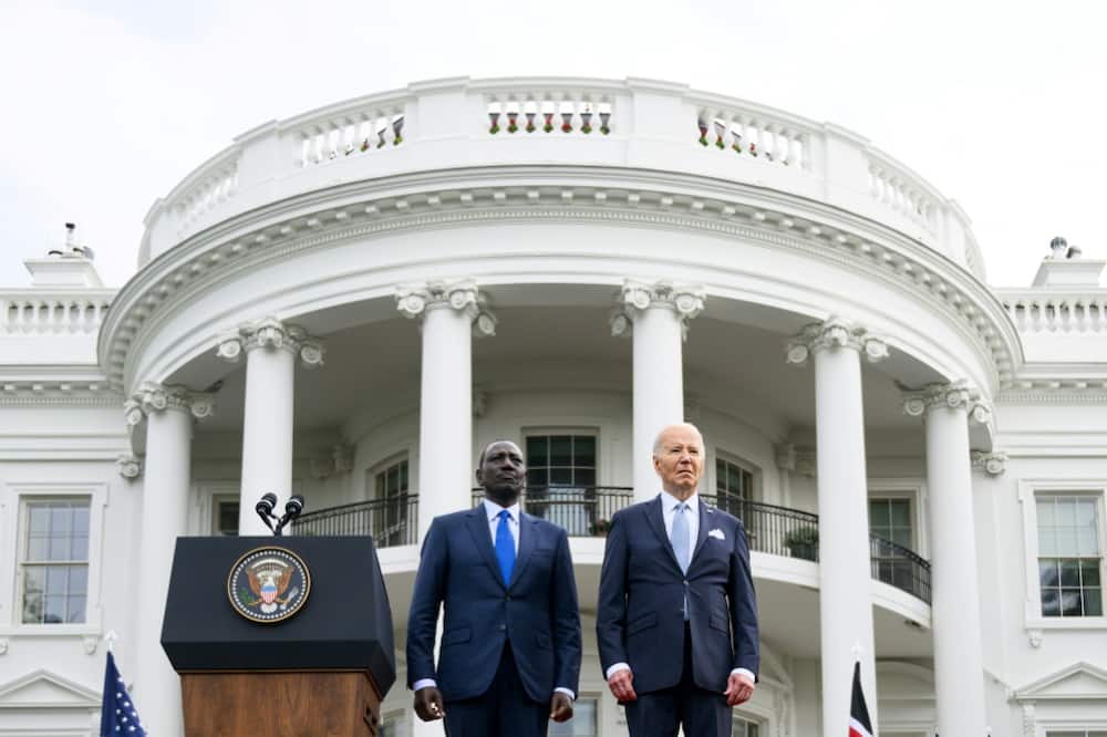 US President Joe Biden (R) and Kenya's President William Ruto stand as national anthems are played during an official arrival ceremony on the South Lawn of the White House in Washington, DC