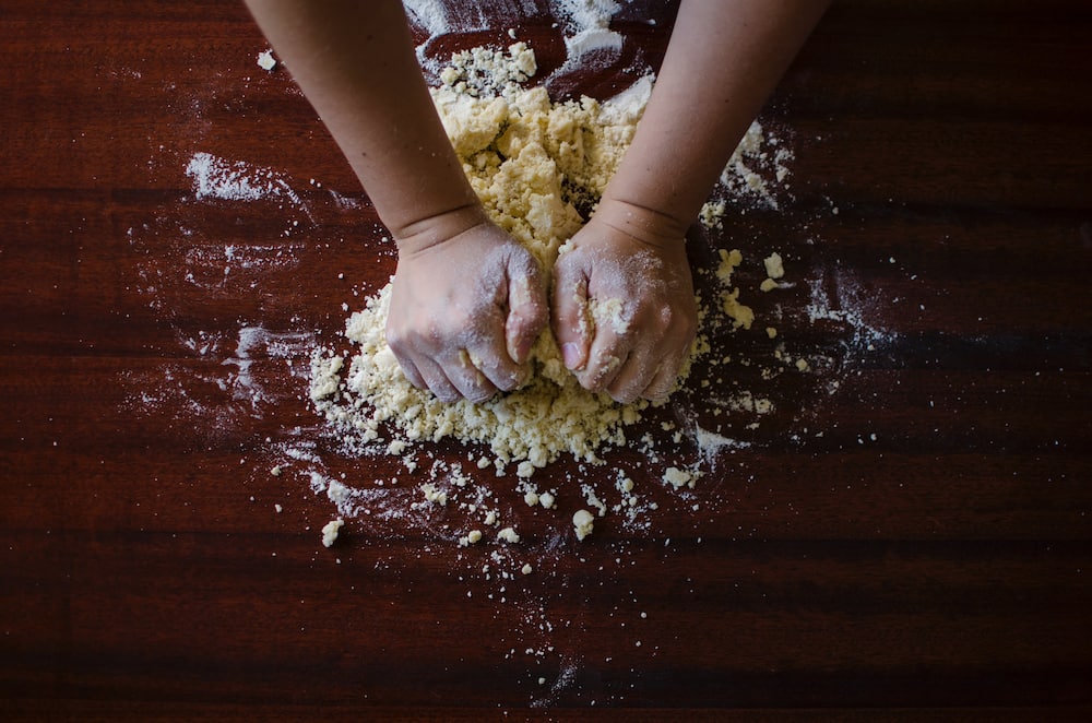 A person mixing dough.