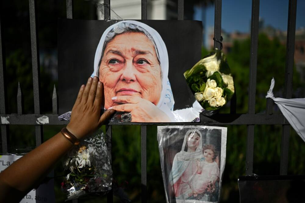 A woman touches a picture of the late Hebe de Bonafini during a ceremony at the Plaza de Mayo in Buenos Aires on November 24, 2022