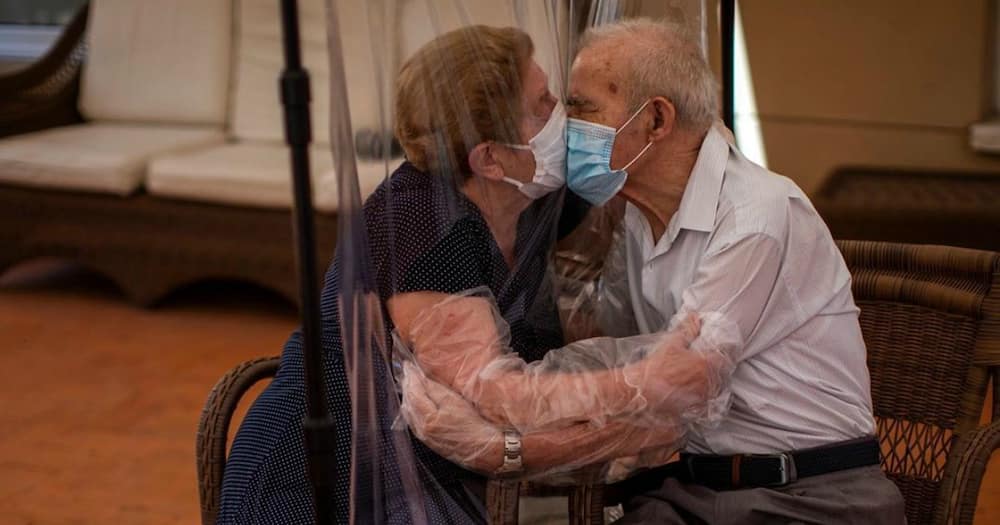 Heartwarming moment as elderly couple is allowed to hug through plastic screens