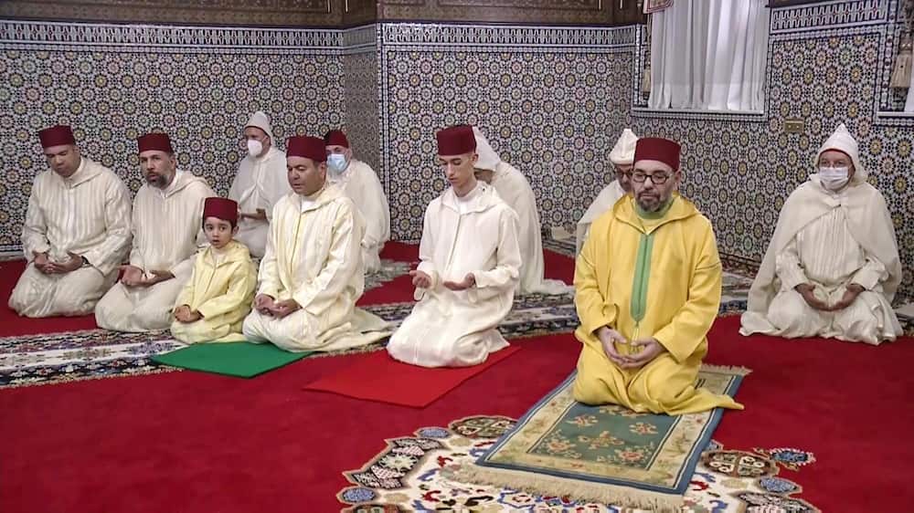 Wearing a yellow robe and appearing thinner, Morocco's King Mohammed VI was seen smiling at the end of the prayers next to his son and his brother Prince Moulay Rachid, 52, images broadcast on public television showed