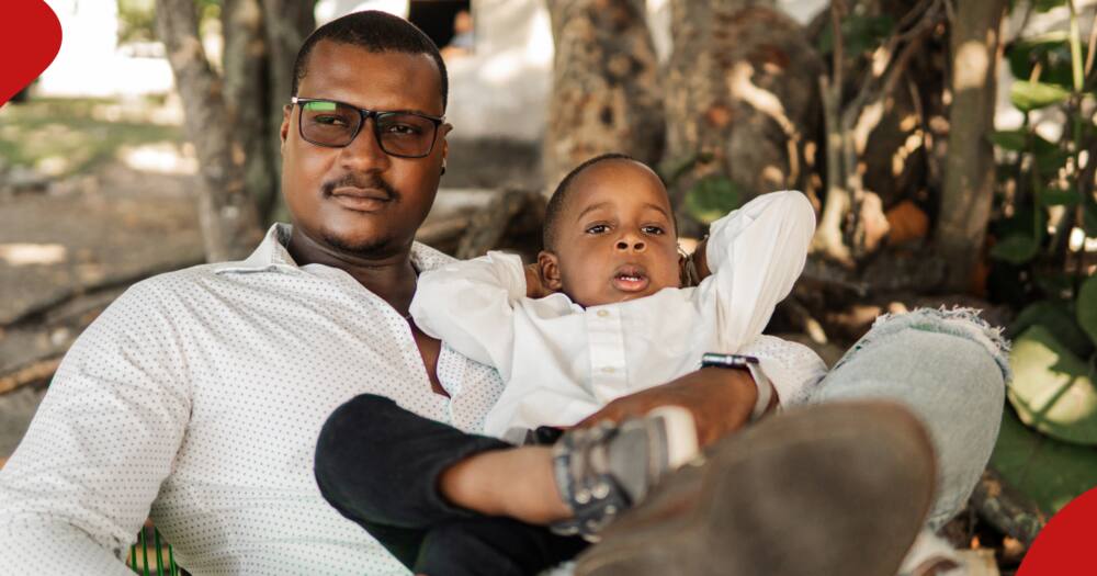 A man relaxing with a boy wearing white shirts.