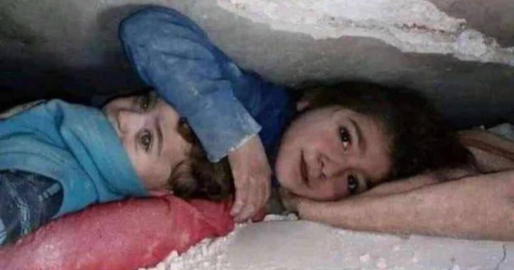 Sister and brother under rubble.