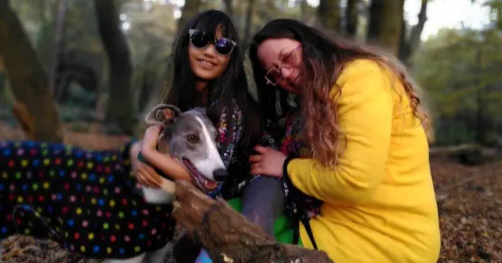 Single mother Ash Ni Leighn (r) and her daughter Sage with their dog.