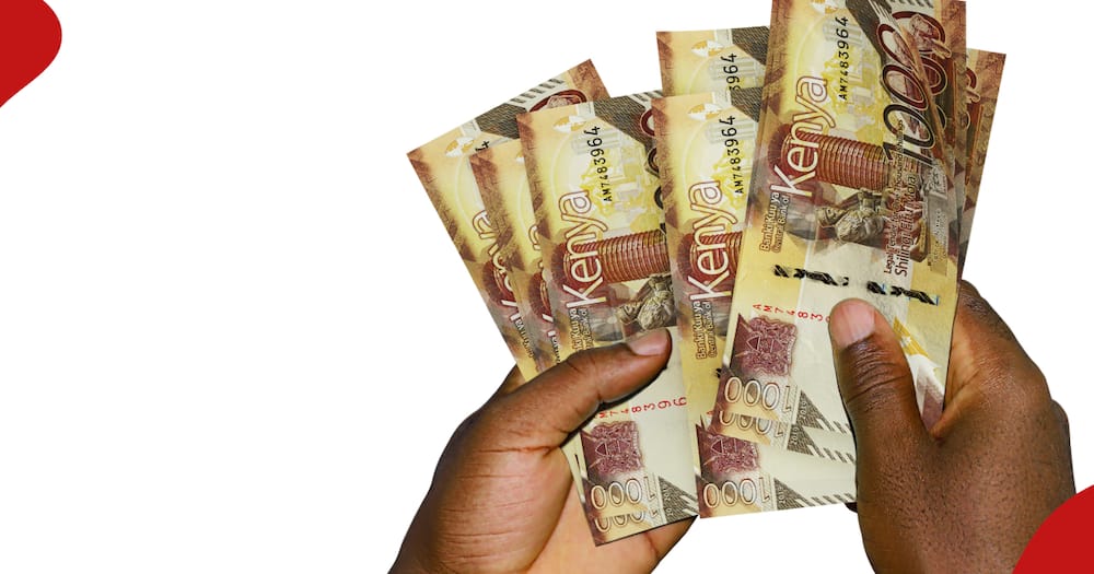 A man holds Kenyan shilling 1000 notes.