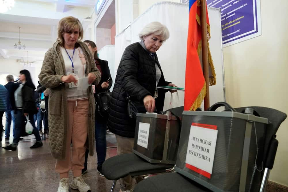 A refugee from Russian-held regions of Ukraine casts a ballot in a referendum in Rostov-on-Don