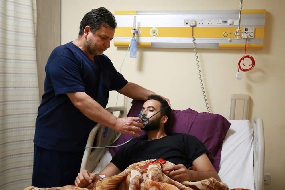 A medic helps a man suffering from breathing difficulties after inhaling chlorine gas during Monday's leak in the Jordanian port of Aqaba