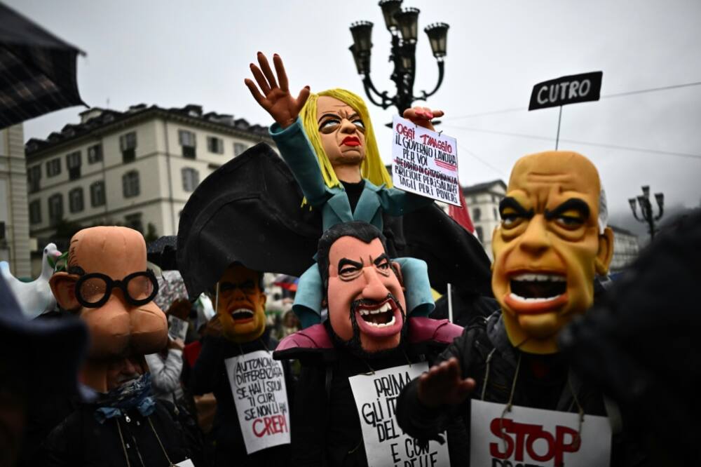 Demonstrators with a puppet of Italy's Prime Minister Giorgia Meloni, centre, at a May Day rally in Turin