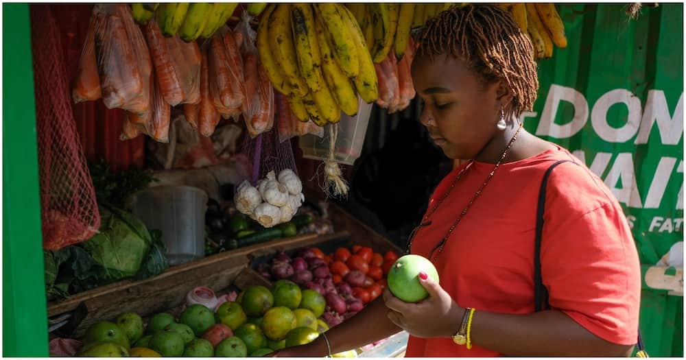 Nairobi woman picking fruits at the market.
