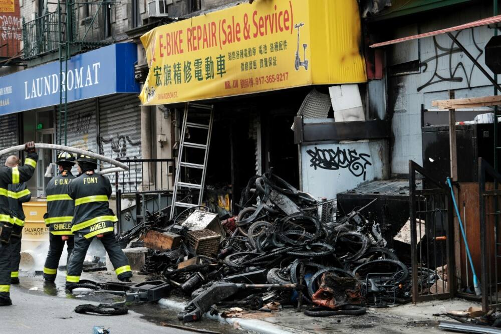 A pile of charred e-bikes lies outside the building where four people died due to the fire