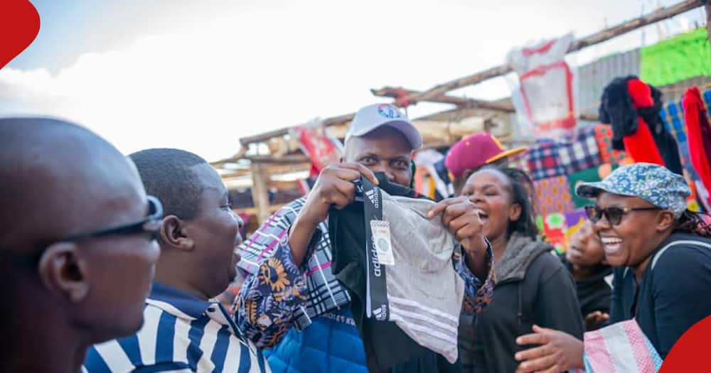 Moses Kuria interacts with second-hand clothe sellers in Nairobi.