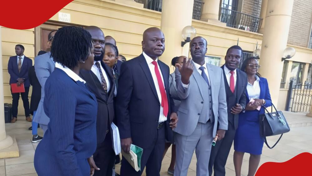 Peter Wanyama, in red tie, and sandwiched by other lawyers at the Milimani Law Courts.