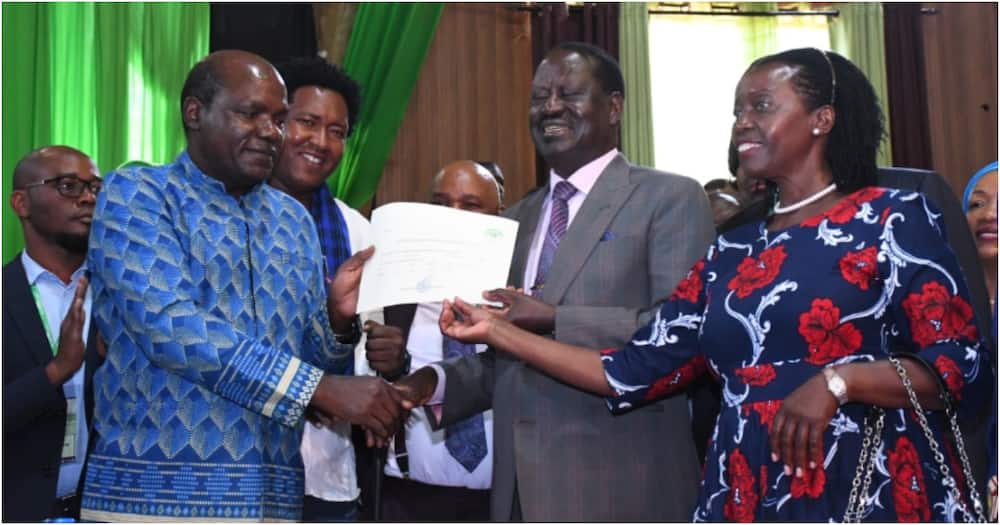 IEBC chair Wafula Chebukati (l) handing registration certificate to Raila Odinga and Martha Karua. Photo: IEBC.