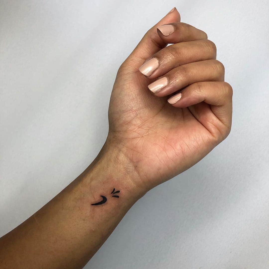 Wrist tattoo of the Om by Sandra Veronika.