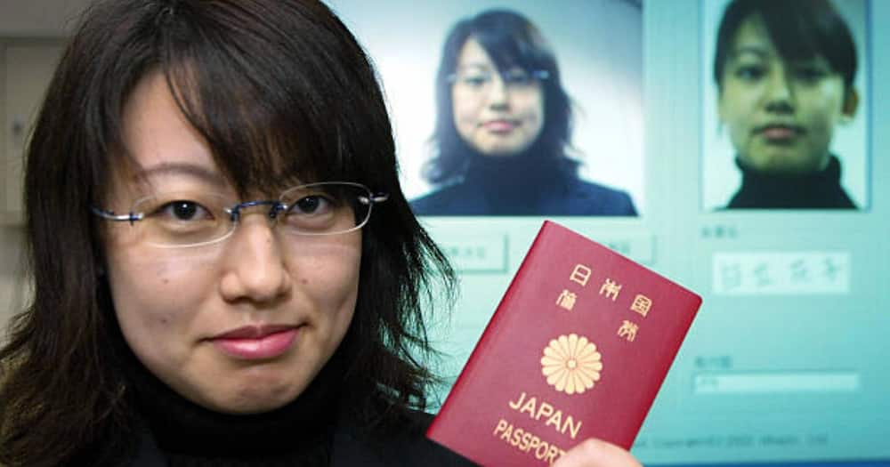 A woman holding a Japanese passport.