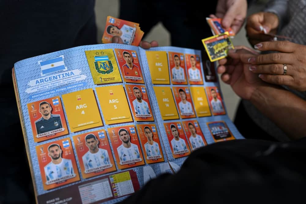 A man exchanges Panini World Cup football stickers at Rivadivia park in Buenos Aires