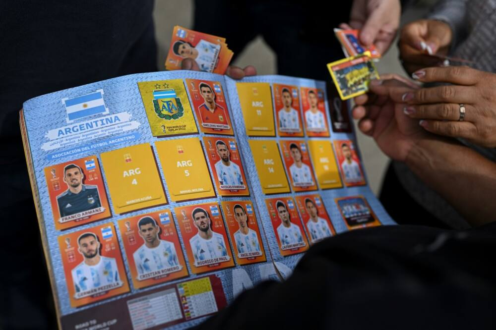 A man exchanges Panini World Cup football stickers at Rivadivia park in Buenos Aires