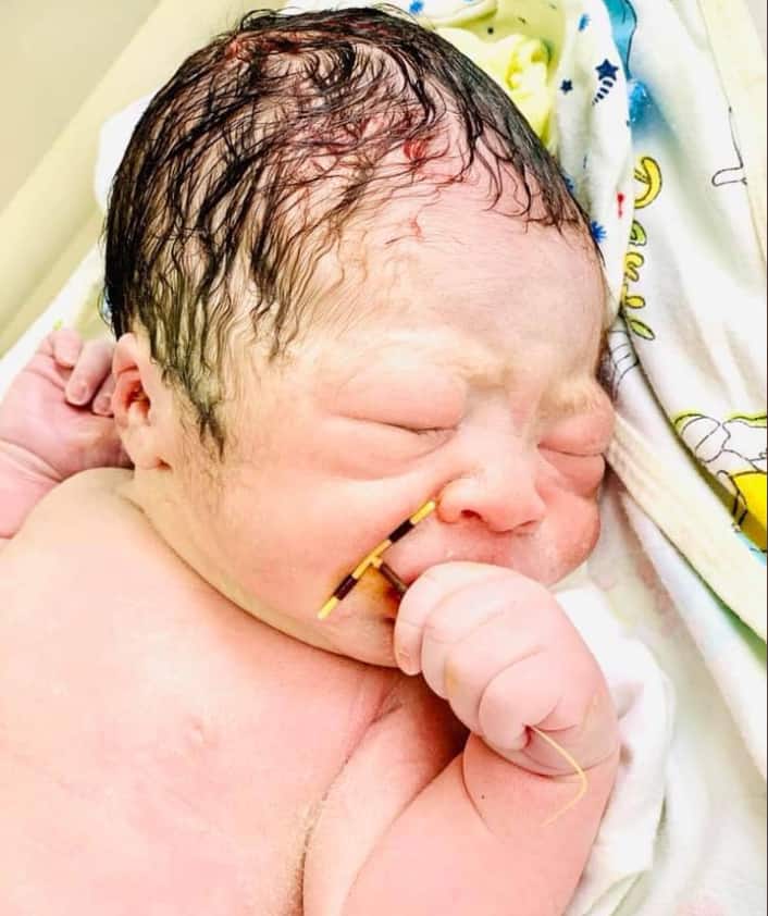 Defiant baby born holding mum's failed IUD in his hand