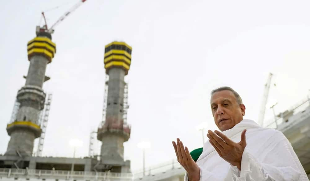 Iraqi Prime Minister Mustafa al-Kadhemi prays near the Kaaba at the Grand Mosque complex in the Saudi holy city of Mecca, as he performs the umra minor pilgrimage, in a picture released by his office on June 26, 2022