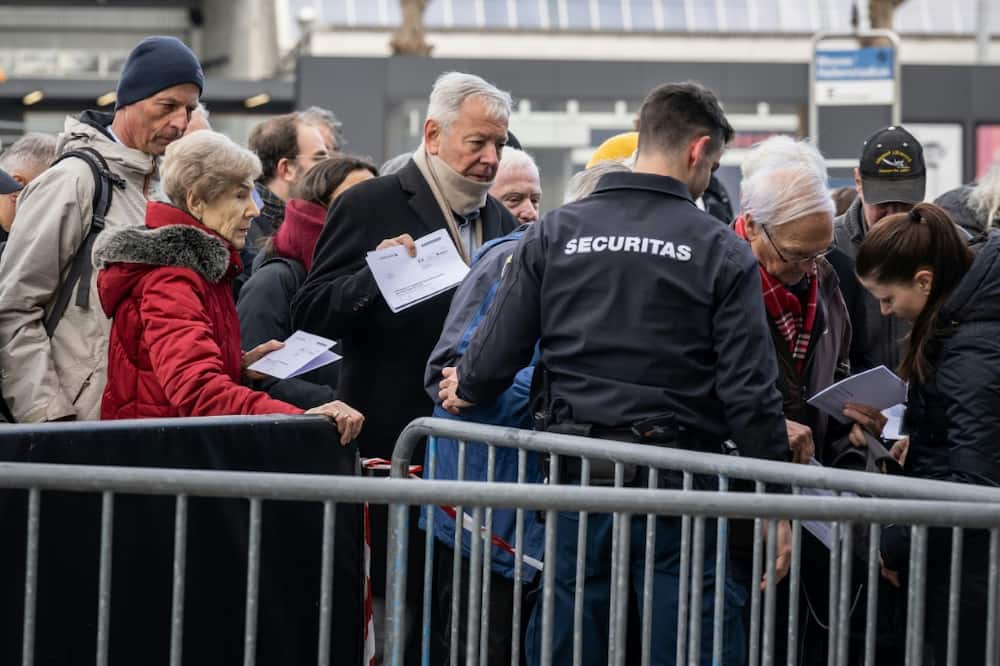 Credit Suisse shareholders went through security checks before entering the bank's annual general meeting at the Hallenstadion concert venue in Zurich